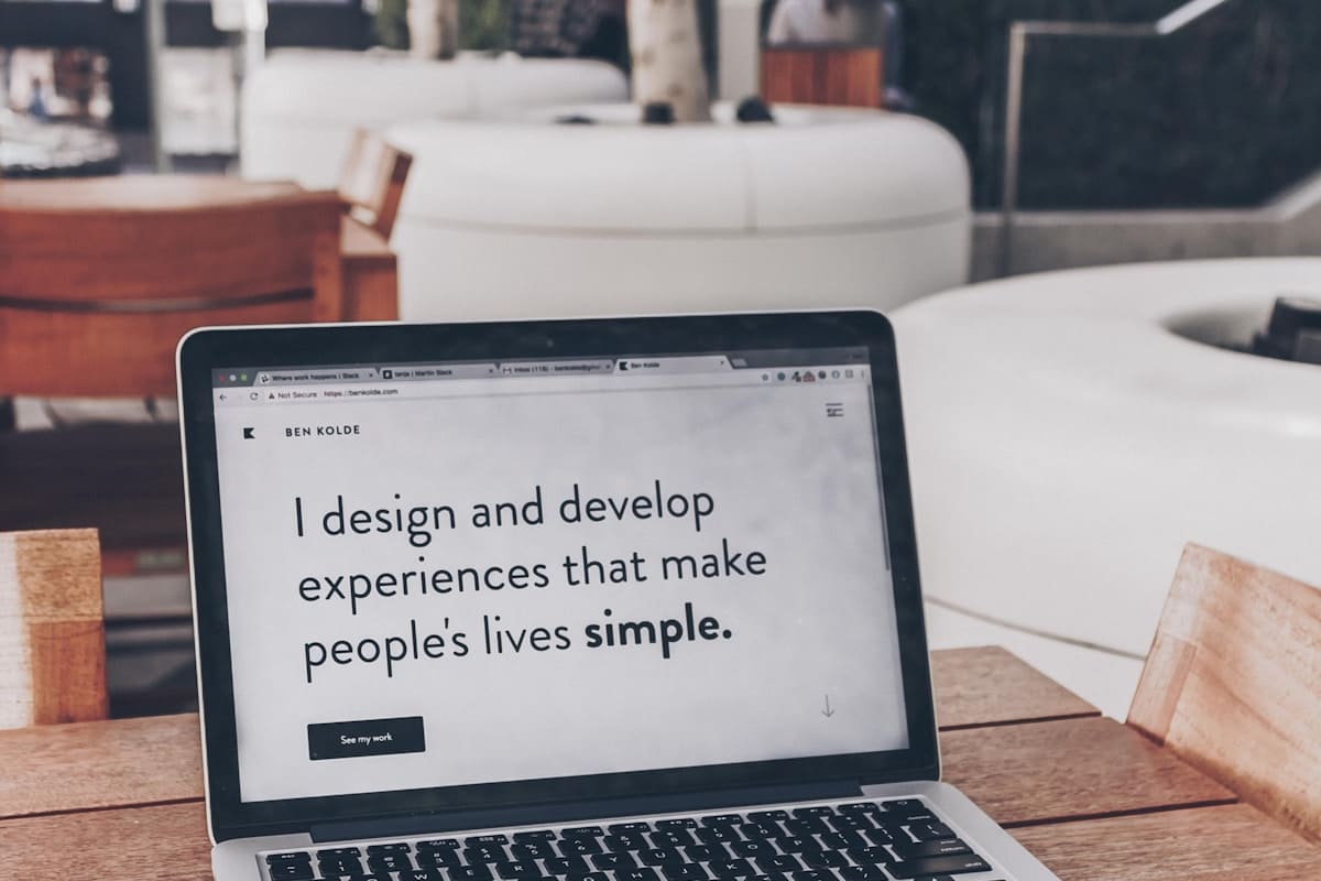 Designer workspace with branding and UX layout materials