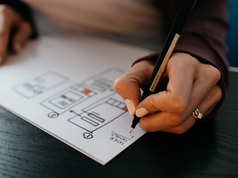Designer sketching UX flows and interface concepts